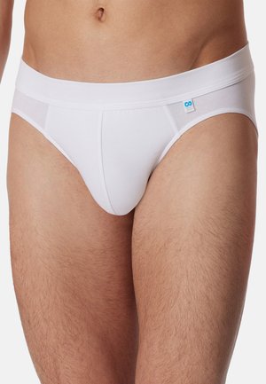 Slip bianco in tessuto morbido con una larga fascia elastica in vita e un piccolo dettaglio di logo blu sul davanti. Tessuto liscio.