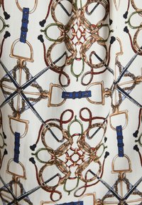 White fabric with intertwining equestrian-themed patterns of stirrups, ropes, and bridles in blue, brown, red, green, and black.