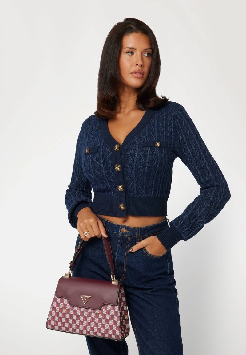 Navy knitted cropped cardigan with textured pattern and gold-tone buttons, paired with a burgundy checkered handbag featuring leather accents.