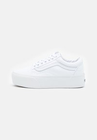 White canvas sneakers with a thick rubber sole, rounded toe, flat lace closure, and side stripe detail. Uniform color and smooth texture.