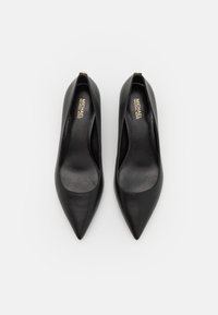 Black leather pointed toe pumps with a sleek design and open sides, featuring branding on the insole and a small golden accent on the heel.
