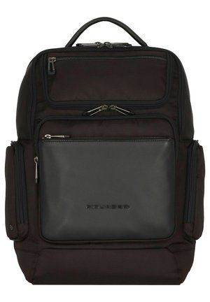 Zaino nero con un'esterno in tessuto testurizzato e un pannello frontale in pelle liscia. Presenta scomparti con zip multipli e una maniglia superiore per il trasporto.