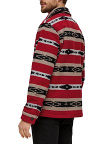 Red and brown plaid shirt with black and gray patterns, featuring a collar and buttoned cuffs, made from soft fabric, shown from the back.