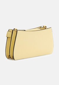 Borsa gialla testurizzata con design curvo, caratterizzata da dettagli neri, tracolla removibile e finitura liscia. Forma compatta e strutturata.