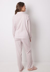 Set di pigiama a righe rosa composto da una maglia con colletto e pantaloni abbinati, con maniche lunghe e vita elastica, realizzato in tessuto morbido.