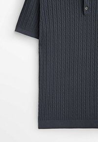 Dark navy short-sleeve polo shirt featuring a ribbed texture, button placket, and a straight hem, made from a soft, knitted fabric.