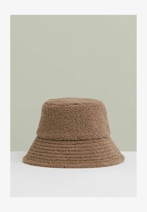 Sombrero de cubo marrón hecho de una tela suave y texturizada. Presenta un ala ancha y una corona cilíndrica con detalles cosidos.