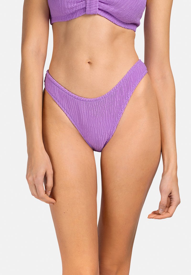 Fioletowe bikini dolne wykonane z teksturowanej tkaniny o wysokim kroju. Posiada gładkie, elastyczne wykończenie i minimalne pokrycie.