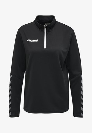 Pullover nera a zip a quarto con tessuto testurizzato. Presenta una cerniera bianca e il logo "hummel". Motivo a chevron grigio sulle maniche.