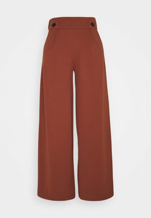 Wide-leg trousers in rust color, made of smooth fabric. Features a high waistband with two black buttons and front pockets.