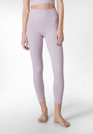Ljuslila leggings i stretchigt material, med hög midja, sömlöst design och en figurnära silhuett ner till anklarna.