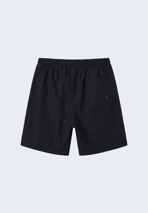 Pantaloncini neri con vita elastica e una singola tasca posteriore con un piccolo occhiello metallico sul lato destro.