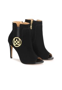 Bottines en suède noir à bout ouvert, avec des talons stilettos, des détails en métal doré décoratifs et une fermeture éclair à l'arrière. Doublure intérieure lisse.