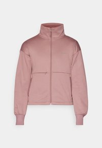 Mauve full-zip jacket with stand collar, zippered chest pocket, side pockets, and elastic cuffs.