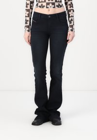 Mørkeblå flagrende jeans med en klassisk fem-lommers design. Laget av denim, med knappelukking og subtile sømdetaljer.