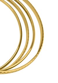 Gold metal bangles, three varying widths, featuring smooth and textured surfaces. Circular shape with polished finish, intricate hammering detail.
