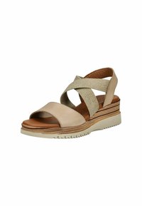 Beige Leder-Sandalen mit glitzernden Kreuzriemen, einem braunen Fußbett und einer geschichteten Keilsohle mit strukturierten Seiten und einem gemusterten Profil.