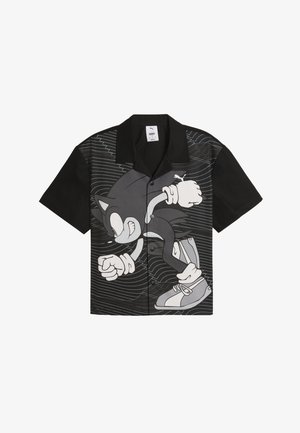 Schwarzes kurzärmliges Hemd mit Knopfleiste, das auf einer Seite eine große graue Grafik eines Cartoon-Charakters zeigt, mit wellenförmigen Linien im Hintergrund.