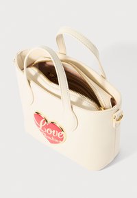White faux leather handbag with rounded handles, featuring a gold-accented heart design labeled "Love Moschino" and a zippered compartment.