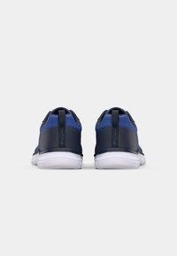 Blue athletic shoes with a textured upper, black accents, and a white rubber sole. Features a small logo on the back and a pull tab.