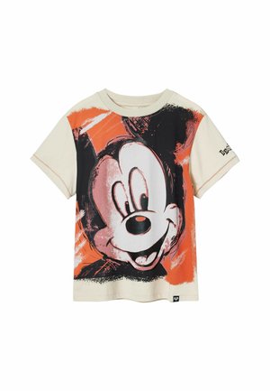 Kortærmet creme T-shirt med et stort sort og orange grafik af en tegneseriefigur på forsiden.