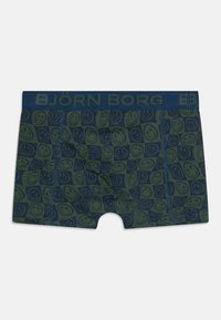 Mørkegrønne boksershorts med et smilende ansigt mønster, med et blåt elastisk liv bæltet som viser "BJÖRN BORG" i matchende blå tekst.