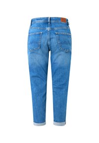 Blauwe spijkerbroek gezien van achteren met opgerolde pijpen, twee achterzakken en een bruin leren merkembleem op de tailleband.