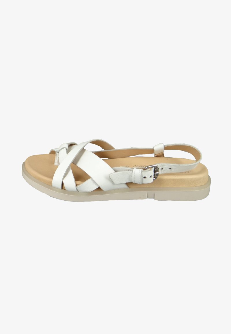 White leather sandal with crisscross straps, adjustable buckle, and a padded footbed on a light-colored outsole.