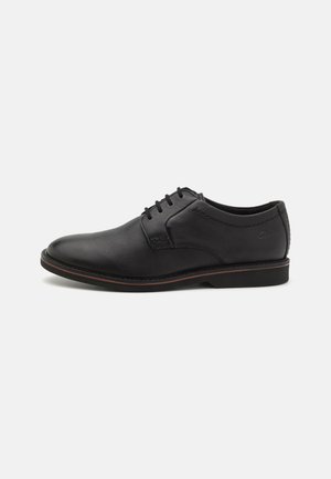 Black leather lace-up shoes with a rounded toe, smooth texture, subtle stitching details, and a contrasting sole edge.