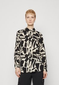 Svart og beige knappet skjorte med et abstrakt geometrisk mønster. Lange ermer, krage og glatt stoff.