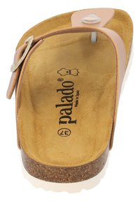 Tan korkfotbäddssandal med suéde-liknande yta, beige remmar och en vit gummisula. Utrustad med en silverfärgad spänne och varumärkeslogotyp.