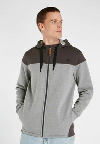 Gray and dark brown zip-up hoodie with a kangaroo pocket, drawstring hood, and contrasting color blocks. Features a logo on the chest.