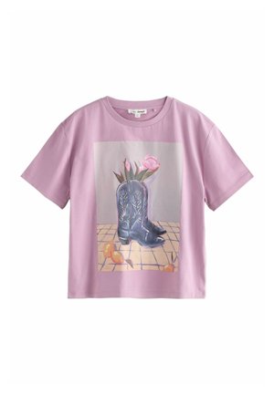 Light pink short-sleeve T-shirt featuring a front graphic of black cowboy boots with floral accents and a tiled background.