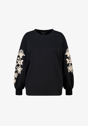 Sweat-shirt noir avec manches longues bouffantes. Présente une broderie florale crème sur la manche gauche. Fabriqué à partir d'un tissu doux et texturé.