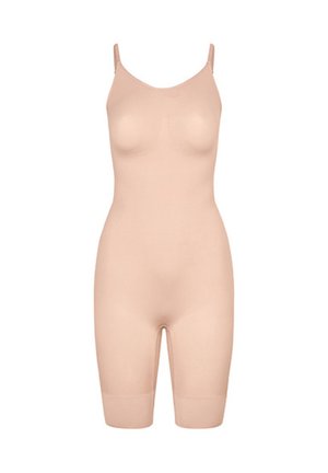 Guêpière intégrale couleur chair sans coutures, avec fines bretelles réglables et couvrant jusqu'au milieu de la cuisse.