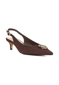 Brown suede slingback shoe with a pointed toe, low heel, and decorative metallic embellishment on the front. Smooth inner lining.
