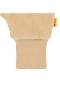 Beige fleece kledingstuk met een zachte, gestructureerde oppervlakte. Is voorzien van een contrasterende ribbelmanchet en een klein geel label met een berenafbeelding.