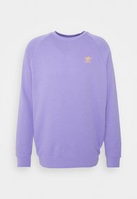 Purple sweatshirt with a crew neck and ribbed cuffs. Features raglan sleeves and a small orange logo on the chest. Soft texture.