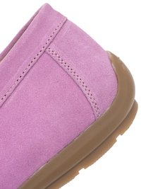 Close-up of pink suede slipper with beige rubber sole showing stitched seams and soft texture.