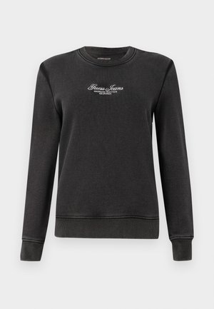 Svart sweatshirt laget av myk stoff, med rund hals, lange ermer og brodert "Guess Jeans" tekst på brystet.