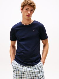 Navy blue cotton t-shirt with a crew neck, featuring a small logo detail. Paired with plaid shorts in light blue, green, and yellow tones.