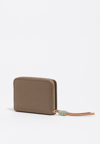 Brown zippered wallet with a sleek rectangular shape, featuring a textured surface and a decorative zipper pull with a woven accent.