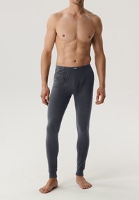 Męskie szare legginsy termiczne wykonane z miękkiej, elastycznej tkaniny. Posiadają dopasowany krój i elastyczny pas z otworem z przodu.