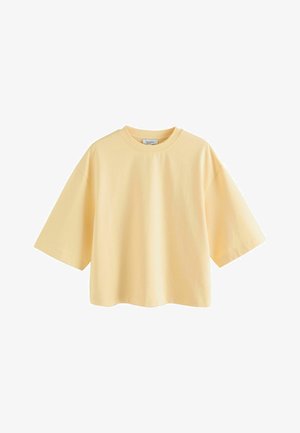 Gelbes, übergroßes T-Shirt mit kurzen Ärmeln aus weicher Baumwolle, mit Rundhalsausschnitt und lockerem Schnitt sowie minimalen Nahtdetails.