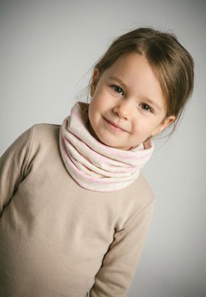 Young girl with brown hair wearing a beige shirt and a light pink speckled neck warmer, smiling gently against a plain gray background.