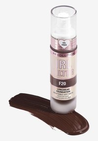 Transparent pumpflaska med foundation med en ljus rosa och brun etikett. Mörkbrun foundation-swatch nedan. 23 ml kapacitet. Olje-fri formula.