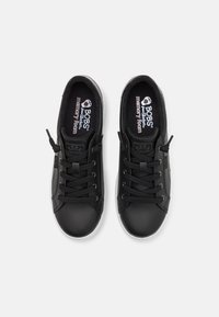 Black synthetic sneakers with round toes, lace-up design, padded collar, contrasting white rubber soles, and textured memory foam insoles.