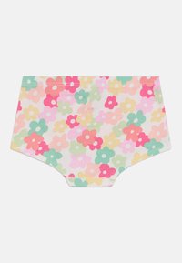 Bomullstruse med hvit bakgrunn, prydet med flerfargede blomstermønstre i rosa, gult, grønt og blått. Myk tekstur, elastisk midje.