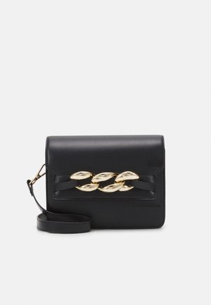 Black leather handbag with a flap closure, featuring a gold-tone chain detail. Includes a detachable strap for versatility.