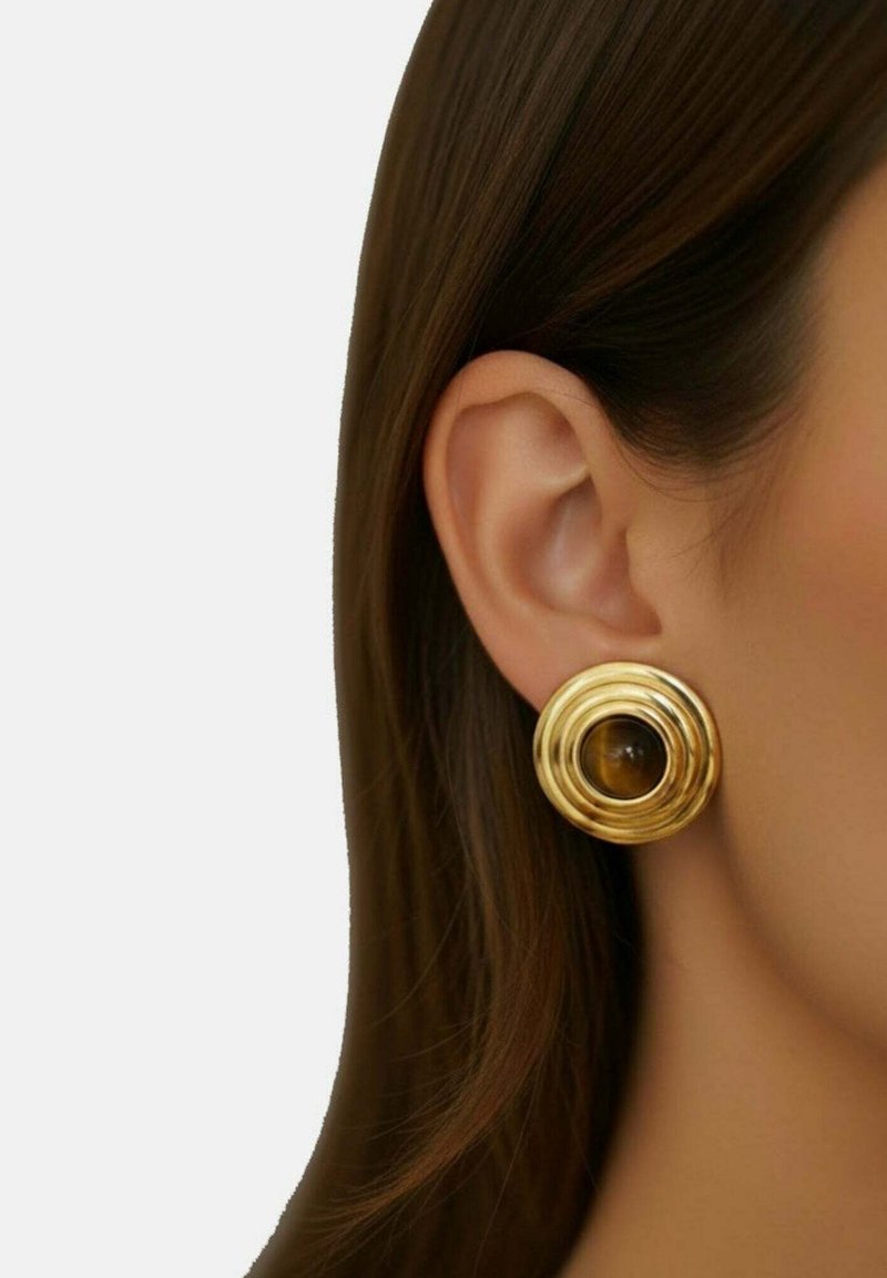 Gold circular earrings with layered spiral design and a central brown stone. Smooth texture and shiny finish.